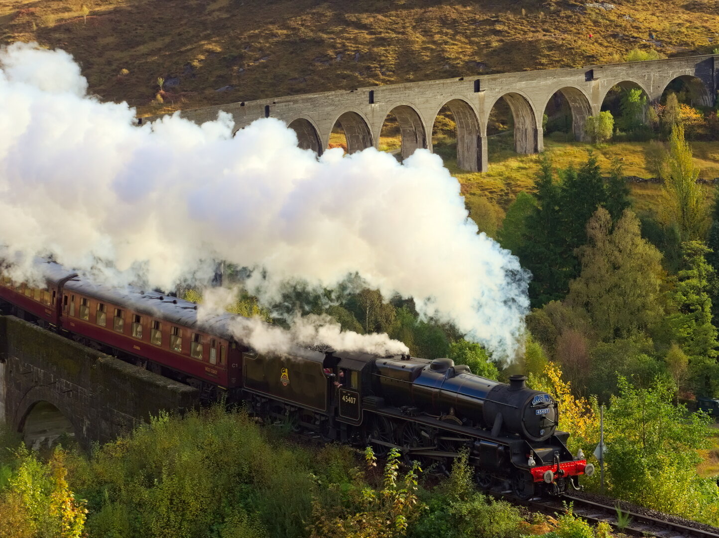 Jacobite steam train crossing the Glenfinnan Viaduct in the Scottish Highlands
